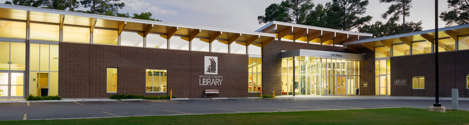 Monticello branch exterior at dusk with windows illuminated