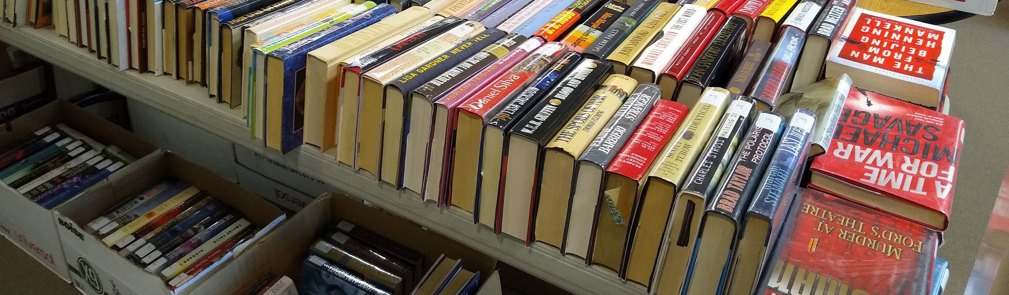 books arranged on table and in boxes for sale