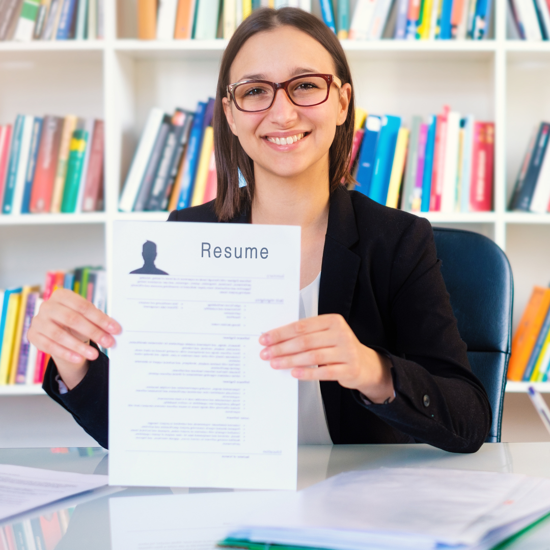 Image of woman holding a resume.