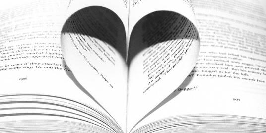 Open book with middle pages rolled into heart shape