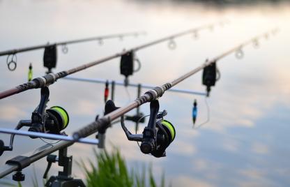 Fishing rods on stand over water